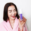 Kvinna med Diamond Smile lila tandblekning - färgkorrigerande serum i handen